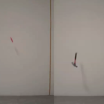 A knife (left) and a hammer (right) are both mid-air in front of a white wall, captured as they fall toward the ground.
