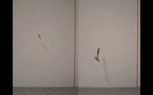 A knife (left) and a hammer (right) are both mid-air in front of a white wall, captured as they fall toward the ground.