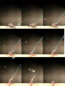 A sequence of eight photos shows colorful strings and confetti bursting from a small box against a dark background.