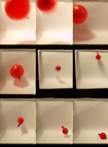 A red balloon deflates and falls in stages, shown in nine sequential photos against a white background.